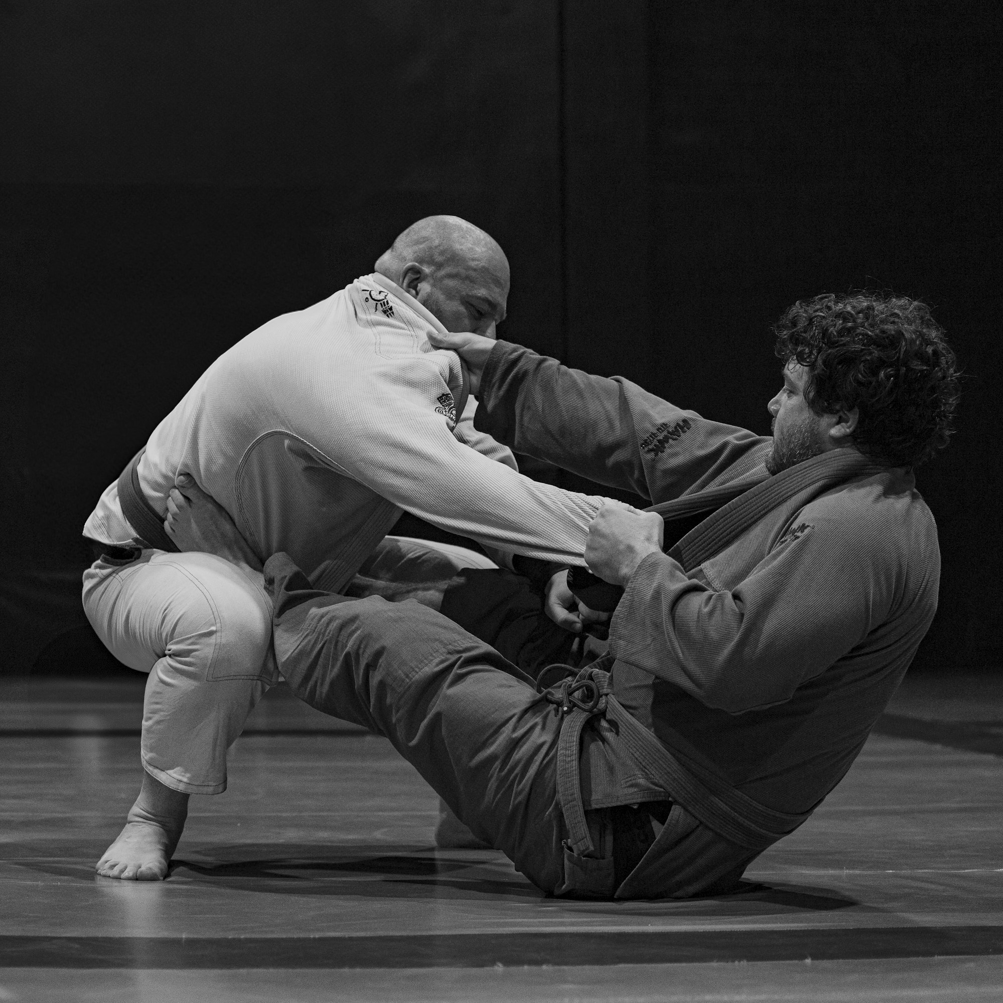 Two grapplers training on the mat